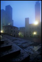 Piazza del Duomo at dawn in the fog. San Gimignano, Tuscany, Italy