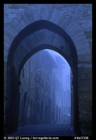 Arch at dawn in the fog. San Gimignano, Tuscany, Italy (color)