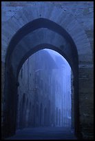 Arch at dawn in the fog. San Gimignano, Tuscany, Italy