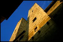 Medieval tower seen from the street, early morning. San Gimignano, Tuscany, Italy