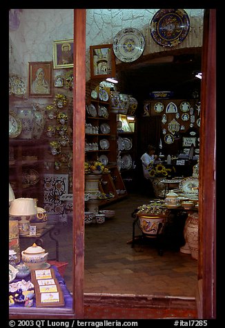 Woman painting plates in a ceramic store. Orvieto, Umbria