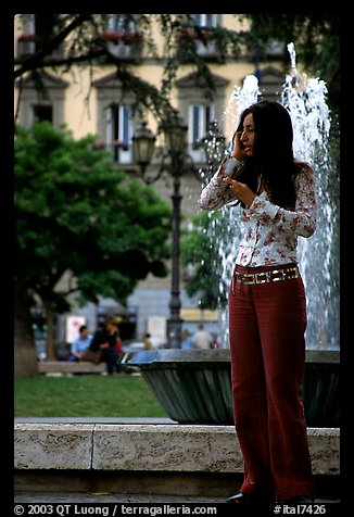 Young woman talking on a cell phone. Naples, Campania, Italy (color)