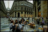 Women enjoy gelato inside the Galleria Umberto I. Naples, Campania, Italy