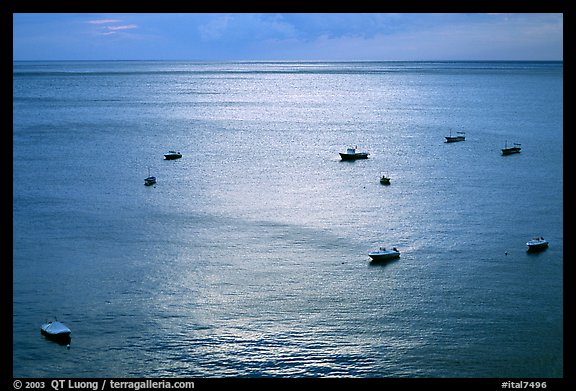 Small boats at sunset in the Gulf of Salerno, Positano. Amalfi Coast, Campania, Italy