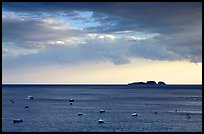 Small boats and Capri Island at sunset, Positano. Amalfi Coast, Campania, Italy (color)