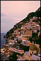 Positano at dawn, with the ceramic dome of Chiesa di Santa Maria Assunta in the foreground. Amalfi Coast, Campania, Italy