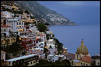 Chiesa di Santa Maria Assunta and houses on steep hills at dusk, Positano. Amalfi Coast, Campania, Italy