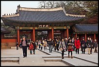 People walking down gate, Changdeok Palace. Seoul, South Korea (color)