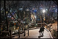 Couple walking down Namsan stairs by night. Seoul, South Korea ( color)