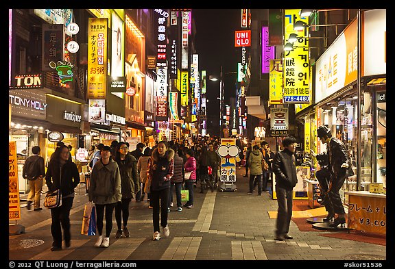 Shoppers on pedestrian street by night. Seoul, South Korea