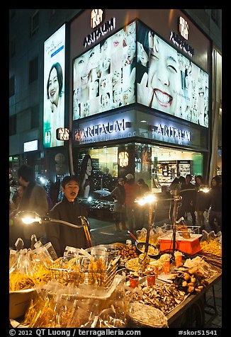 Street food vendor and cosmetics store by night. Seoul, South Korea