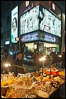 Street food vendor and cosmetics store by night. Seoul, South Korea (color)
