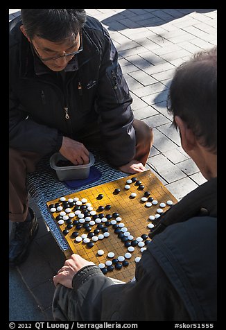 Pondering moves in go (baduk) game. Seoul, South Korea (color)