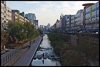 Pedestrians walking through Cheonggyecheon river park. Seoul, South Korea (color)