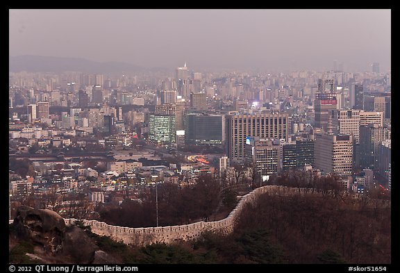 Old fortress wall and high-rises at dusk. Seoul, South Korea