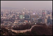 Old fortress wall and high-rises at dusk. Seoul, South Korea ( color)