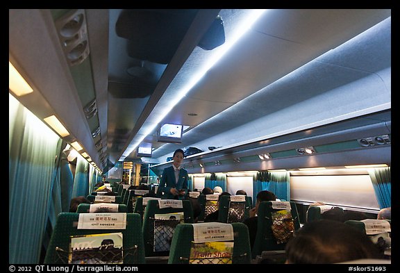 Hostess walking inside high speed KTX train car. Seoul, South Korea (color)