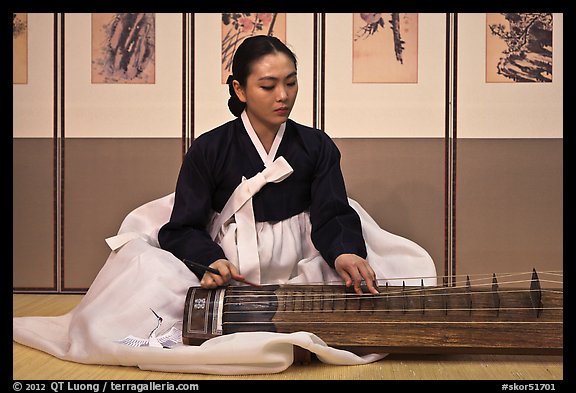 Woman playing traditional instrument. South Korea