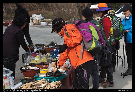 Hikers check out stand selling natural products. South Korea (color)