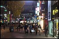 Shoppers strolling on pedestrian street at night. Daegu, South Korea ( color)