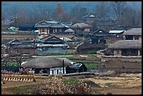 Straw roofed houses and tile roofed houses. Hahoe Folk Village, South Korea (color)