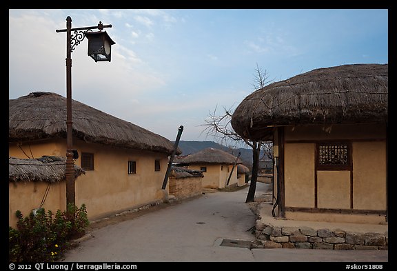 Alley bordered by straw roofed houses. Hahoe Folk Village, South Korea