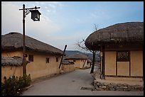 Alley bordered by straw roofed houses. Hahoe Folk Village, South Korea