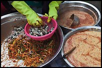 Hands mixing kim chee. Gyeongju, South Korea (color)