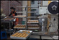 Woman baking Gyeongju barley bread. Gyeongju, South Korea (color)