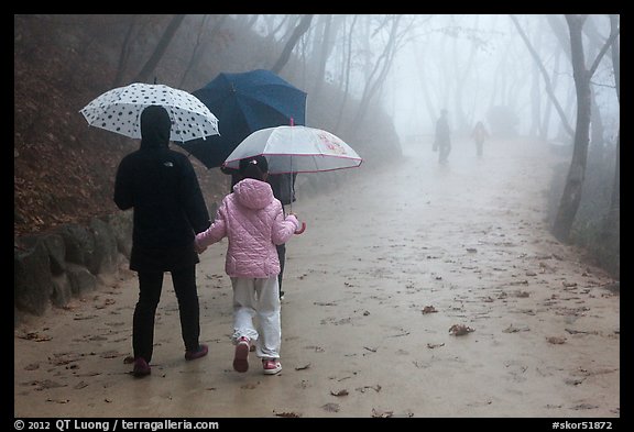 Family walking on misty path, Seokguram. Gyeongju, South Korea (color)