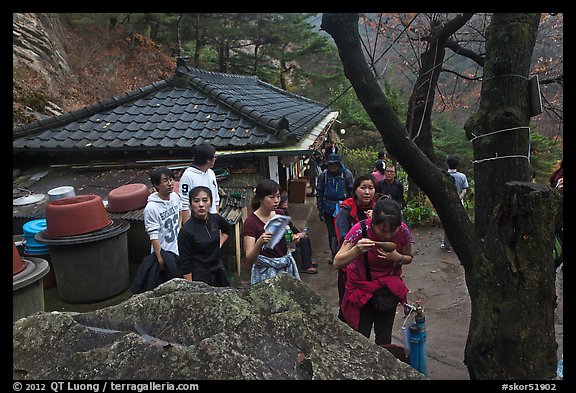 Hikers drinking from foundtain at Sangseonam hermitage, Namsan Mountain. Gyeongju, South Korea (color)