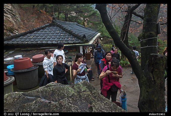 Hikers drinking from foundtain at Sangseonam hermitage, Namsan Mountain. Gyeongju, South Korea