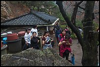 Hikers drinking from foundtain at Sangseonam hermitage, Namsan Mountain. Gyeongju, South Korea ( color)
