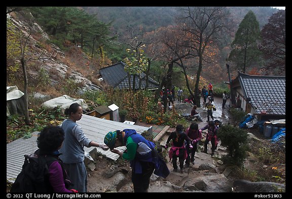 Hikers receiving sacred bread at Sangseonam hermitage, Mt Namsan. Gyeongju, South Korea (color)