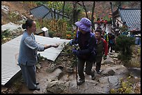 Woman giving sacred bread at Sangseonam hermitage, Namsan Mountain. Gyeongju, South Korea