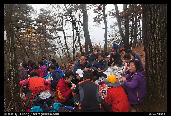 Large group of hikers eating on Geumobong Peak, Namsan Mountain. Gyeongju, South Korea (color)