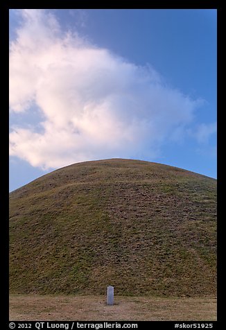 Mound of earth raised over grave and cloud. Gyeongju, South Korea (color)