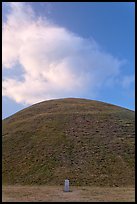 Mound of earth raised over grave and cloud. Gyeongju, South Korea