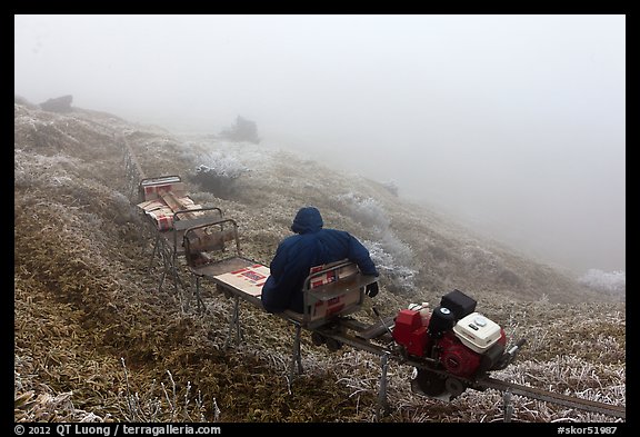 Man riding monorail on mountain, Mount Halla. Jeju Island, South Korea (color)