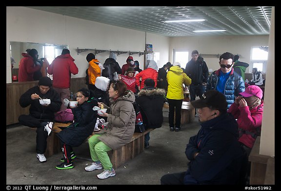 Hikers eating noodles inside Witseoreum shelter, Hallasan. Jeju Island, South Korea