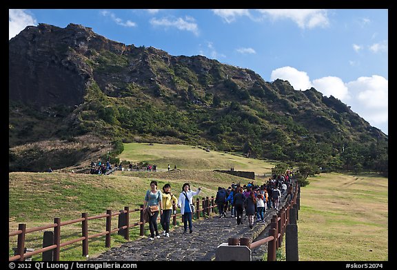 Seongsang Ilchulbong and tourists on path. Jeju Island, South Korea