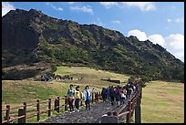 Seongsang Ilchulbong and tourists on path. Jeju Island, South Korea