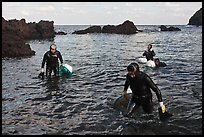 Women divers emerging from water. Jeju Island, South Korea ( color)