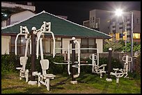 Exercise equipment in yard at night, Seogwipo. Jeju Island, South Korea (color)