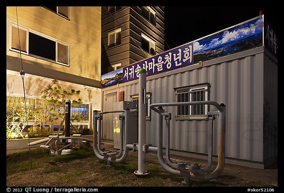 Public exercise equipment and buildings at night, Seogwipo. Jeju Island, South Korea (color)