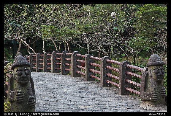 Footbridge and Dolharubang statues, Seogwipo. Jeju Island, South Korea (color)