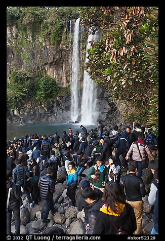 Crowd at the base of waterfall, Jeongbang Pokpo, Seogwipo. Jeju Island, South Korea (color)