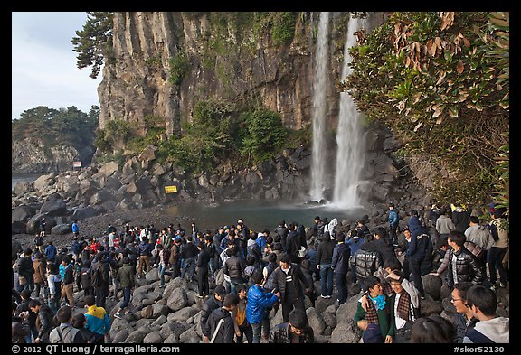 Tourists at the base of Jeongbang Pokpo falls, Seogwipo. Jeju Island, South Korea (color)