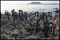 Tourists on rocky beach, Seogwipo. Jeju Island, South Korea ( color)