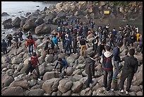 Crowd on rocky beach, Seogwipo. Jeju Island, South Korea ( color)